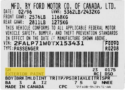 Close-up of Ford paint code label on a vehicle door jamb