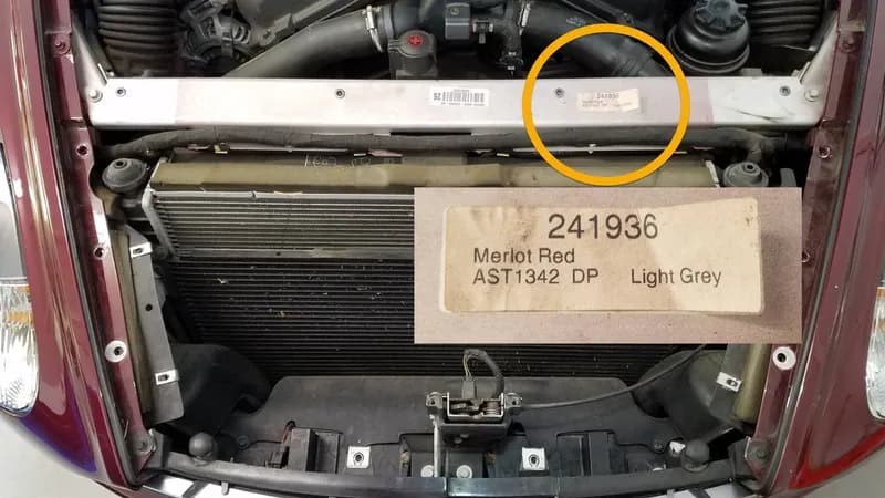 Close-up of Aston Martin paint code label on a vehicle door jamb