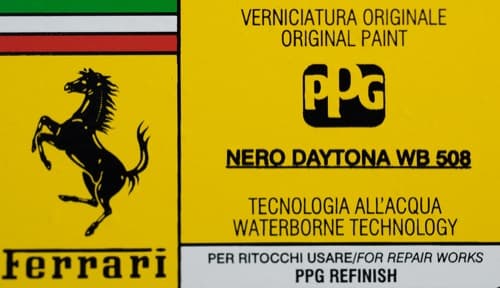 Close-up of Ferrari paint code label on a vehicle door jamb