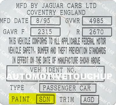 Close-up of Jaguar paint code label on a vehicle door jamb