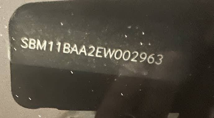 Close-up of McLaren paint code label on a vehicle door jamb